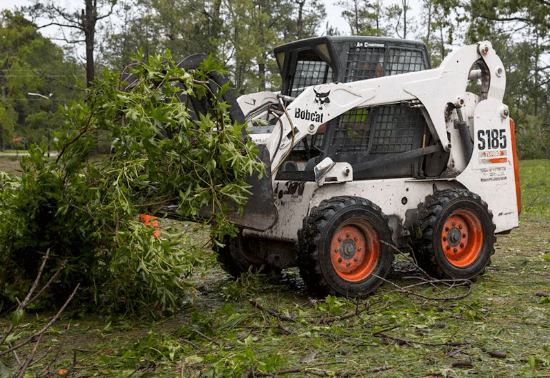 Bobcat clearing debris